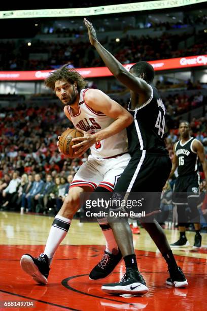 Robin Lopez of the Chicago Bulls dribbles the ball while being guarded by Andrew Nicholson of the Brooklyn Nets in the first quarter at United Center...