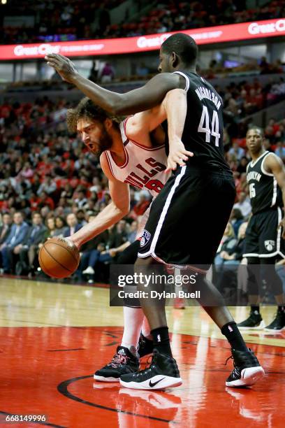 Robin Lopez of the Chicago Bulls dribbles the ball while being guarded by Andrew Nicholson of the Brooklyn Nets in the first quarter at United Center...