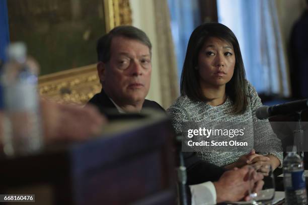 Flanked by Stephen Golan, one of her father's attorneys, Crystal Dao Pepper, the daughter of Dr. David Dao, listens to questions during a press...