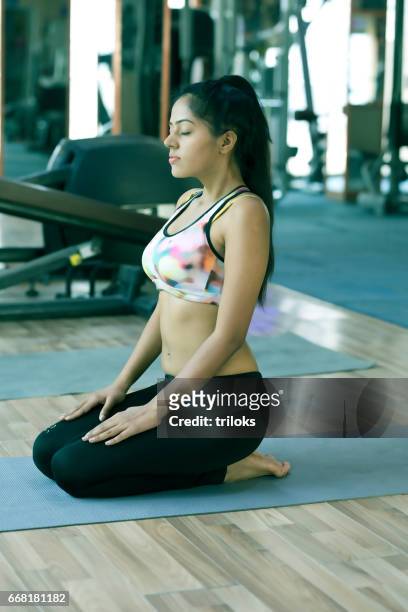 young woman practicing yoga - yoga studio stock pictures, royalty-free photos & images