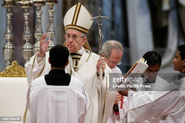 Pope Francis delivers his blessing as he leads the Chrism Mass for Holy Thursday which marks the start of Easter celebrations in St. Peter's Basilica...