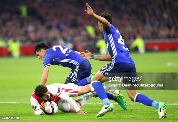 Amin Younes of Ajax is fouled by Alessandro Schopf of FC Schalke 04 leading to a penalty scored by Davy Klaassen during the UEFA Europa League...