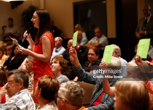 Lindsey Perkins asks a question during a town hall meeting held by Rep. Joe Barton at Mansfield City Hall on April 13, 2017 in Mansfield, Texas. A...