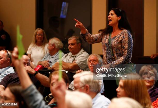 An attendee asks a questions during a town hall meeting held by Rep. Joe Barton at Mansfield City Hall on April 13, 2017 in Mansfield, Texas.