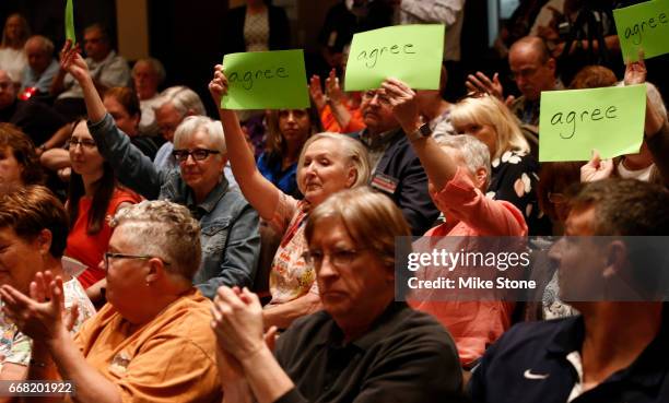 From left, Sharon Stephens and Sharon Timmons, both of Arlington, express their approval as a point is made to Rep. Joe Barton responds to a question...