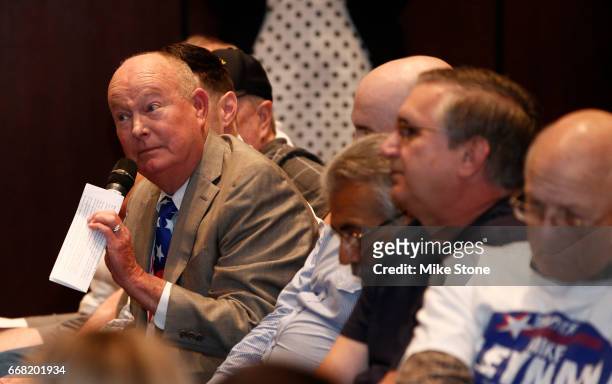 An attendee asks a question of Rep. Joe Barton during a town hall meeting at Mansfield City Hall on April 13, 2017 in Mansfield, Texas. A capacity...