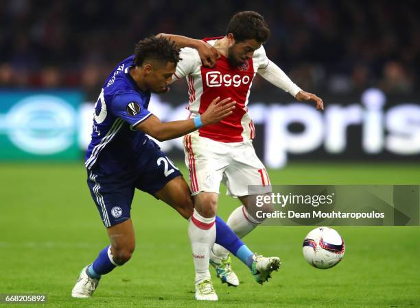 Amin Younes of Ajax and Thilo Kehrer of FC Schalke 04 in action during the UEFA Europa League quarter final first leg match between Ajax Amsterdam...