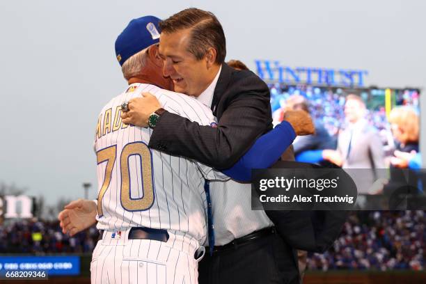 Joe Maddon of the Chicago Cubs is greeted by Cubs Owner Tom Ricketts during the World Series ring ceremony ahead of the game between the Los Angeles...