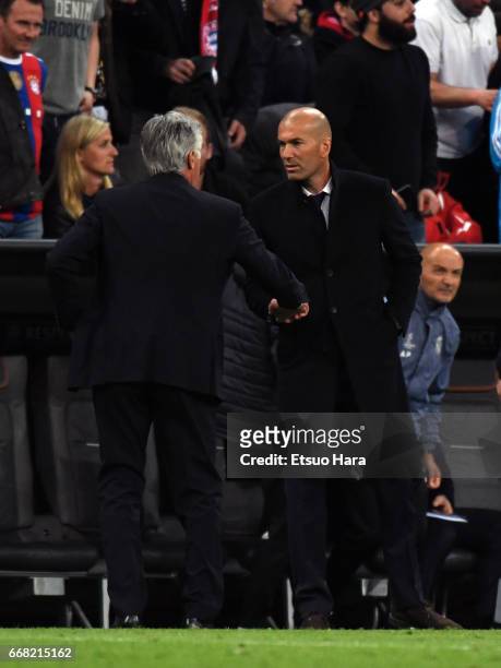 Head coach Carlo Ancelotti of Bayern Muenchen and head coach Zinedine Zidane of Real Madrid shake hands after during the UEFA Champions League...