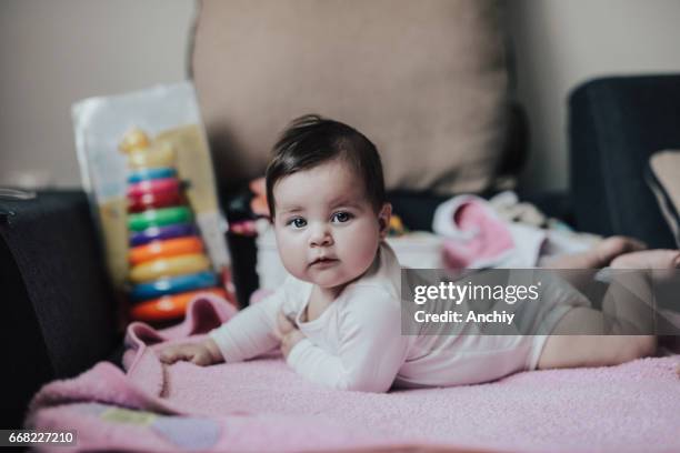 beautiful baby girl on pink blanket - baby girl laying on tummy stock pictures, royalty-free photos & images