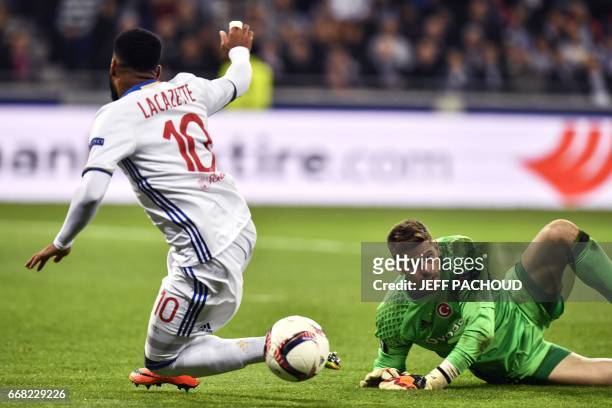 Lyon's French forward Alexandre Lacazette is tackled by Besiktas' Spanish goalkeeper Fabricio Agosto Ramirez during the UEFA Europa League first leg...