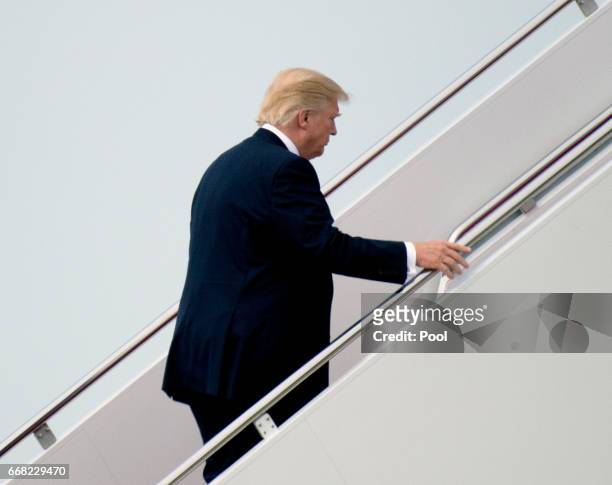President Donald Trump boards Air Force One to fly to West Palm Beach, Florida to spend the Easter Weekend at his Mar-a-Lago resort on April 13, 2017...