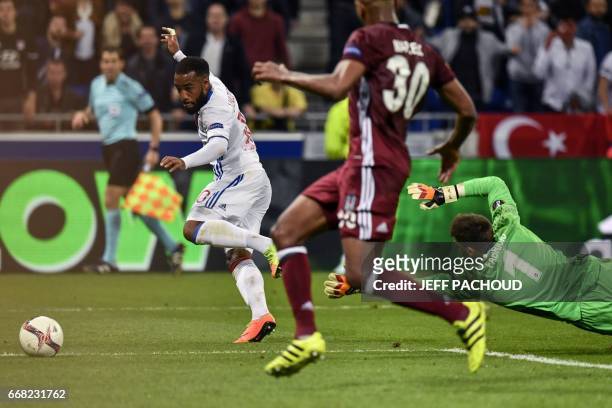Lyon's French forward Alexandre Lacazette tries to score as Besiktas' Spanish goalkeeper Fabricio Agosto Ramirez dives during the UEFA Europa League...