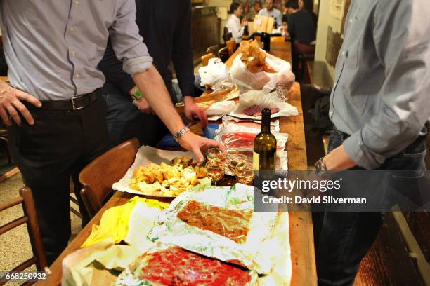 Italian businessmen enjoying a night out together the Osteria Del Sole bar on March 30, 2017 in Bologna, Italy, have brought themselves a table full...