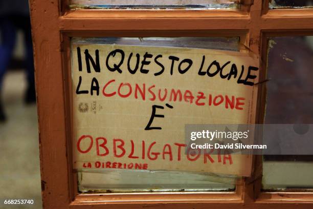 Sign on the door reminds patrons that purchase is compulsory at the Osteria Del Sole bar on March 30, 2017 in Bologna, Italy. Situated on Via...