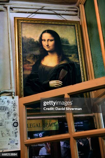 Copy of the Mona Lisa holding a wine glass is hung above the entrance at the Osteria Del Sole bar on March 30, 2017 in Bologna, Italy. Situated on...