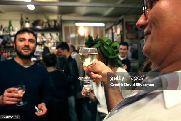 Italian businessmen enjoy a night out together the Osteria Del Sole bar on March 30, 2017 in Bologna, Italy. Situated on Via Ranocchi, an alleyway in...