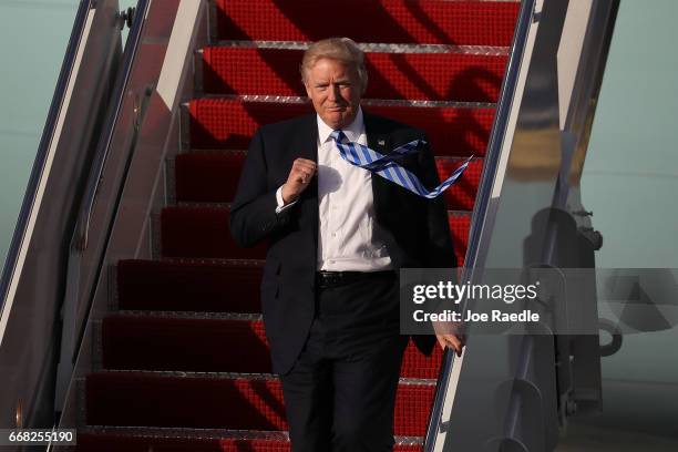 President Donald Trump arrives on Air Force One at the Palm Beach International Airport to spend Easter weekend at Mar-a-Lago resort on April 13,...