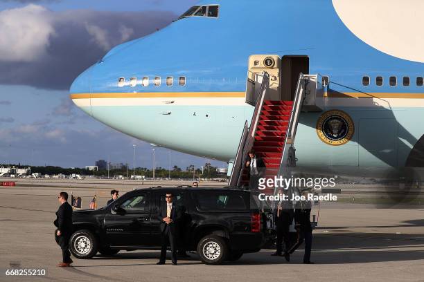 President Donald Trump sits in his vehicle before being driven away after arriving on Air Force One at the Palm Beach International Airport to spend...