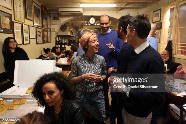 Italian businessmen and students, each holding their own celebration, mingle as the wine flows and the night wears on at the Osteria Del Sole bar on...