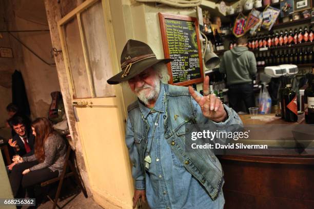 An Italian man reacts as he heads for the courtyard smoking section at the Osteria Del Sole bar on March 30, 2017 in Bologna, Italy. Situated on Via...