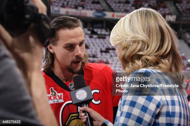 Erik Karlsson of the Ottawa Senators gets interviewed by CBC ringside reporter Christine Simpson during warmups prior to a game against the Boston...