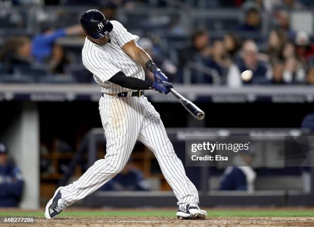 Aaron Hicks of the New York Yankees hits a two run home run in the seventh inning against the Tampa Bay Rays on April 13, 2017 at Yankee Stadium in...