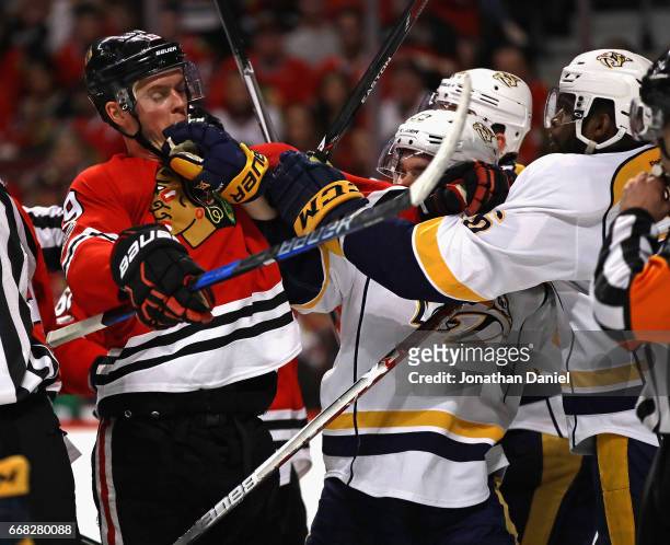 Jonathan Toews of the Chicago Blackhawks gets into a skirmish with members of the Nashville Predators including Colin Wilson in Game One of the...