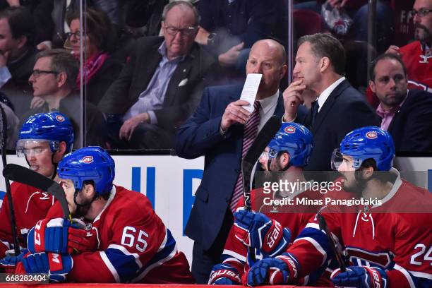 Head coach of the Montreal Canadiens Claude Julien speaks with associate coach Kirk Muller against the New York Rangers in Game One of the Eastern...