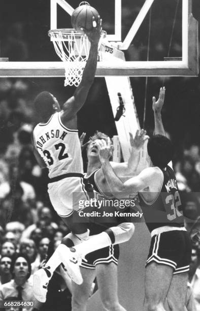 The Lakers Earvin "Magic" Johnson drives to the basket to score against the Boston Celtics Larry Bird and Kevin McHale during the NBA Finals in June...