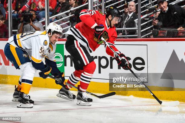 Artem Anisimov of the Chicago Blackhawks controls the puck ahead of Roman Josi of the Nashville Predators in the third period in Game One of the...