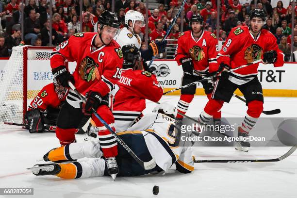 Jonathan Toews and Nick Schmaltz of the Chicago Blackhawks watch the puck in the third period against the Nashville Predators in Game One of the...