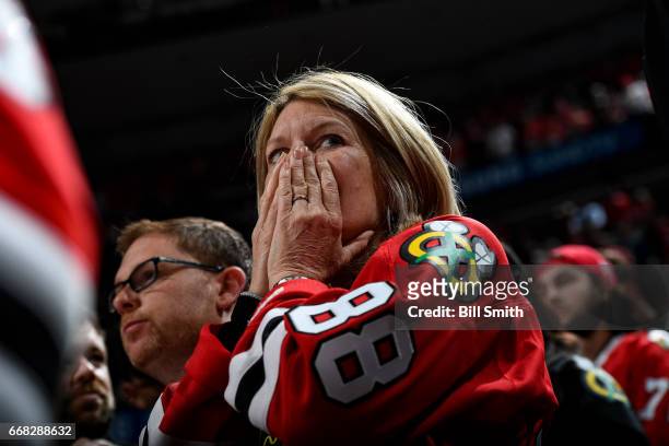 Chicago Blackhawks fan watches the last few minutes in the third period against the Nashville Predators in Game One of the Western Conference First...