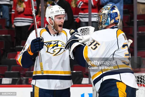 Mattias Ekholm and goalie Pekka Rinne of the Nashville Predators celebrate after defeating the Chicago Blackhawks 1-0 in Game One of the Western...