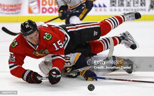 Artem Anisimov of the Chicago Blackhawks is tripped by Viktor Arvidsson of the Nashville Predators in Game One of the Western Conference First Round...