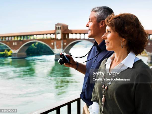 mature couple sightseeing - pavia italy stock pictures, royalty-free photos & images