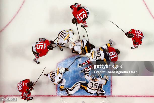 Viktor Arvidsson of the Nashville Predators falls onto Marian Hossa of the Chicago Blackhawks, as Brian Campbell works to get the puck against Colton...