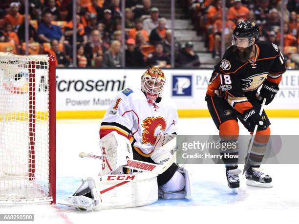 Bill Elliott of the Calgary Flames and Patrick Eaves of the Anaheim Ducks react to a goal from Ryan Getzlaf to take a 1-0 lead during the first...