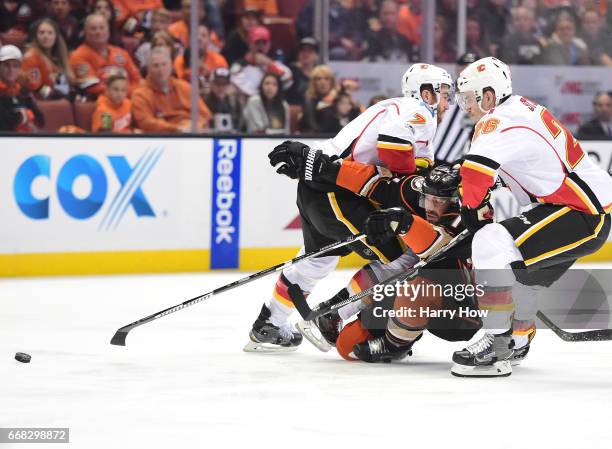 Ryan Kesler of the Anaheim Ducks is checked as he attempts to split the defense of TJ Brodie and Michael Stone of the Calgary Flames during the first...