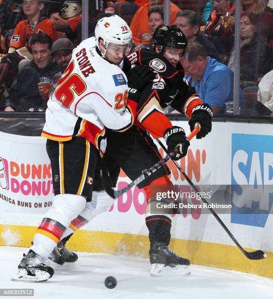 Jakob Silfverberg of the Anaheim Ducks battles for the puck against Michael Stone of the Calgary Flames in Game One of the Western Conference First...