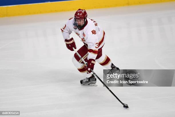 Denver Pioneers defenseman Tariq Hammond controls the puck in the first period of an NCAA Frozen Four semifinal game with the Denver Pioneers and the...