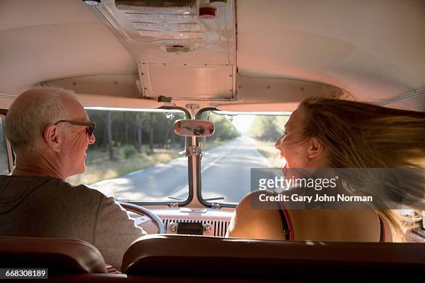 Happy couple on road trip in vintage campervan