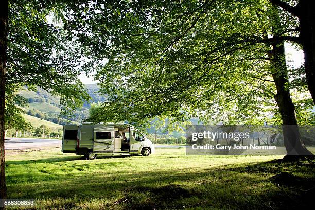 campervan parked in rural landscape in pyrenees - pirineos fotografías e imágenes de stock