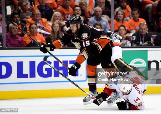 Ryan Getzlaf of the Anaheim Ducks checks Mark Giordano to the ice during a 3-2 Ducks win in Game One of the Western Conference First Round during the...