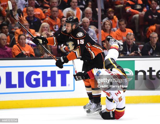 Ryan Getzlaf of the Anaheim Ducks checks Mark Giordano to the ice during a 3-2 Ducks win in Game One of the Western Conference First Round during the...