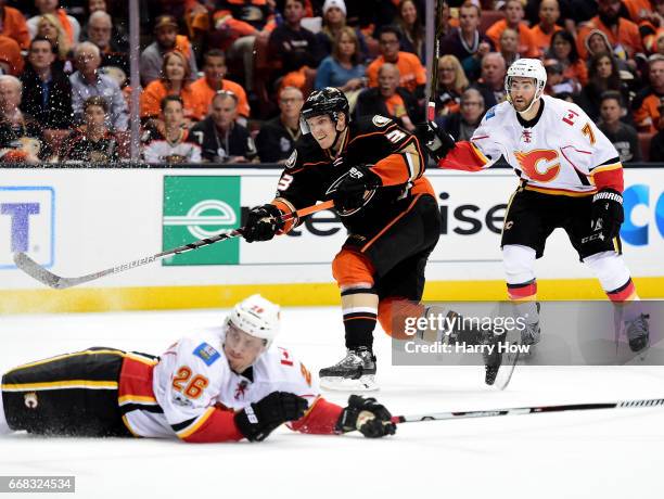 Jakob Silfverberg of the Anaheim Ducks shoots over a sliding Michael Stone of the Calgary Flames during a 3-2 Ducks win in Game One of the Western...