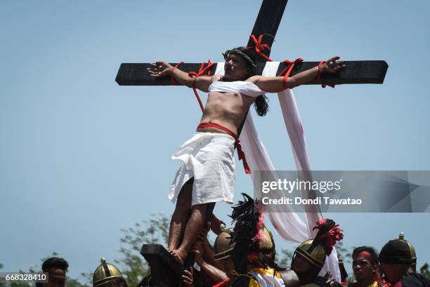 Men are nailed to the cross during Good Friday reenactments of the passion of Christ on April 14, 2017 in San Pedro Cutud village in San Fernando...