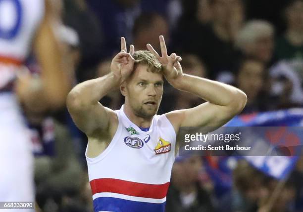Jake Stringer of the Bulldogs celebrates after kicking the first goal on Easter Friday by gesturing with easter bunny ears during the round four AFL...