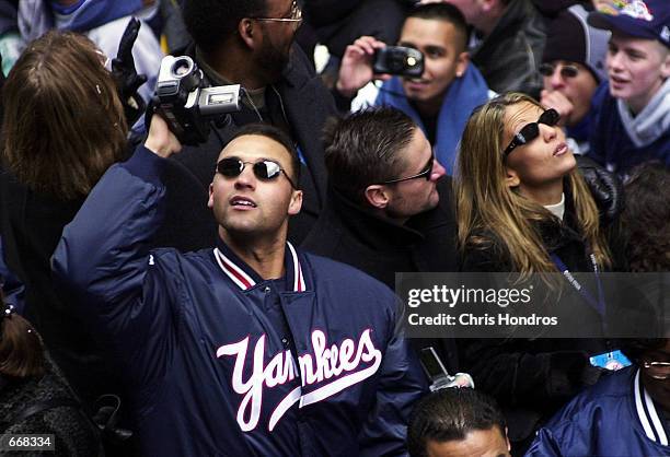 New York Yankee Derek Jeter videotapes the crowd from his float October 30, 2000 during the Yankees'' World Series victory parade in New York City....