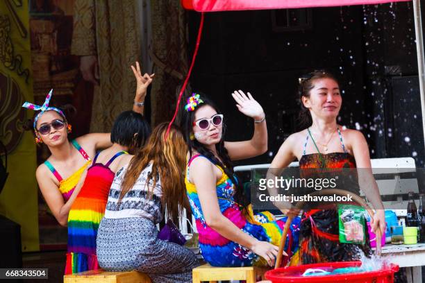 thai women having songkran party on sidewalk - nur frauen stock pictures, royalty-free photos & images